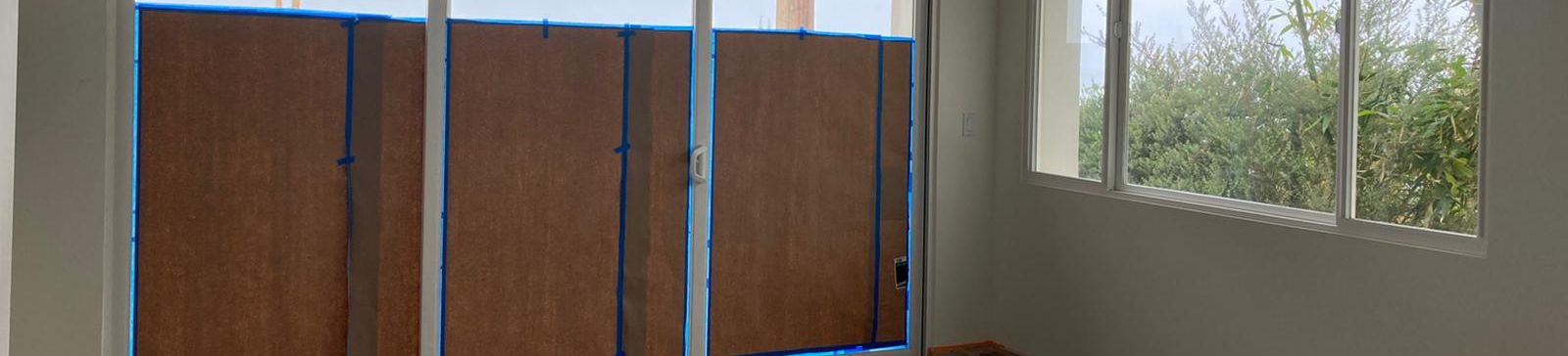 Sliding glass doors with smart automatic shades, providing stylish and functional window coverings for a contemporary home.